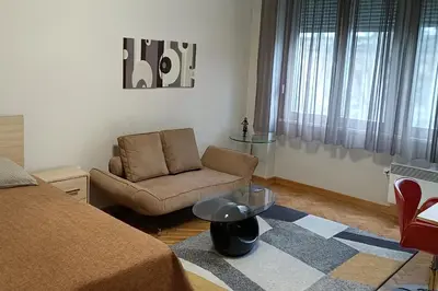 a living room with a couch and a chair at LP apartment in Belgrade
