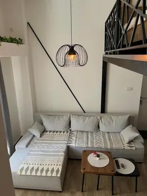 a bed in a room with a table at City Loft in Belgrade