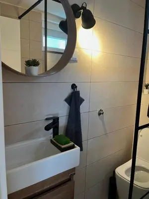 a bathroom with a sink and a mirror at City Loft in Belgrade