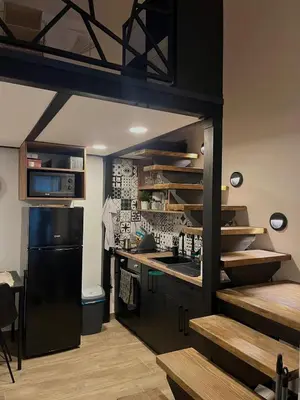 a kitchen with a black refrigerator and a stove at City Loft in Belgrade