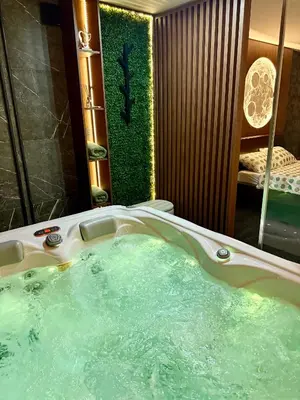 a bathroom with a bath tub with a mirror at Moon Apartment Belgrade in Belgrade