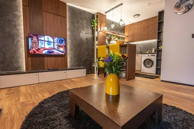 a living room with a table with flowers on it at Moon Apartment Belgrade in Belgrade