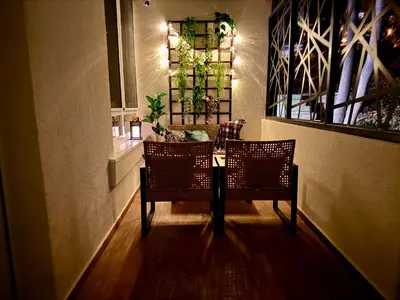 a hallway with two chairs and a table with lights at Moon Apartment Belgrade in Belgrade