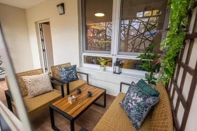 a balcony with two chairs and a table at Moon Apartment Belgrade in Belgrade