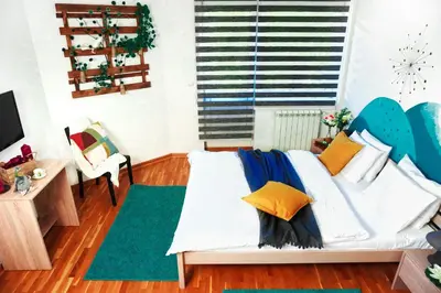 a bedroom with a bed with pillows on it at Villa K Apartments in Belgrade