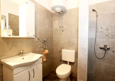 a bathroom with a toilet and a sink and a shower at Villa K Apartments in Belgrade
