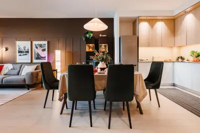 a dining room and kitchen with a table and chairs at WF Timeless Residence with Terrace & Foosball in Belgrade