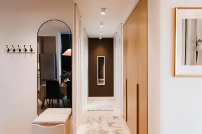 a hallway with a mirror and a dining room at WF Timeless Residence with Terrace & Foosball in Belgrade
