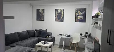 a living room with a couch and a table at Slavuj MINI in Belgrade