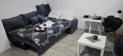 a living room with a couch and a table at Slavuj MINI in Belgrade