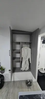 a closet with a white shirt hanging in it at Slavuj MINI in Belgrade