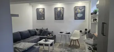 a living room with a couch and a table at Slavuj MINI in Belgrade