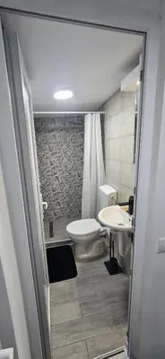 a bathroom with a toilet and a sink at Slavuj MINI in Belgrade