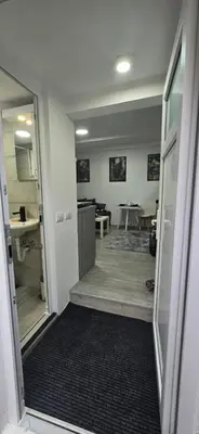 an empty room with a hallway with a sink and a bathroom at Slavuj MINI in Belgrade