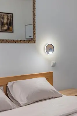 a bedroom with a bed with a mirror on the wall at Nele Belgrade Apartment in Belgrade