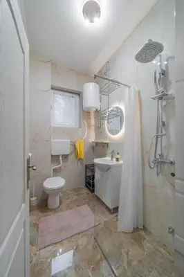a bathroom with a toilet and a sink and a shower at Nele Belgrade Apartment in Belgrade