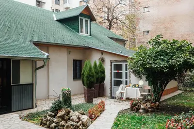 a home with a patio and a house at Foosball Frontyard Retreat Old Town in Belgrade