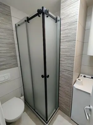 a shower stall in a bathroom with a toilet at VauDa White apartman in Belgrade