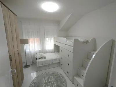 a small white room with a bed and a closet at VauDa White apartman in Belgrade