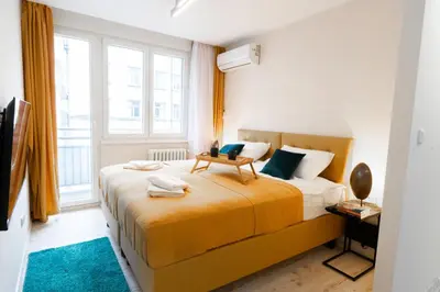 a bedroom with a bed and a large window at Old Town Lounge Belgrade in Belgrade