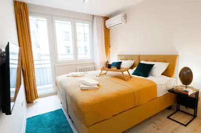a bedroom with a large bed and a large window at Old Town Lounge Belgrade in Belgrade