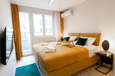 a bedroom with a large bed and a large window at Old Town Lounge Belgrade in Belgrade