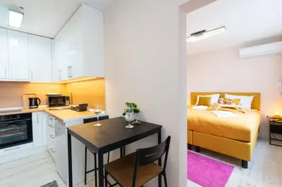 a kitchen and a bedroom with a bed and a table at Old Town Lounge Belgrade in Belgrade