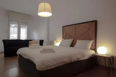 a bedroom with a large bed and a couch at Slavija Square Apartments in Belgrade