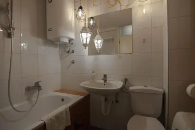 a bathroom with a sink and a toilet and a bath tub at Slavija Square Apartments in Belgrade