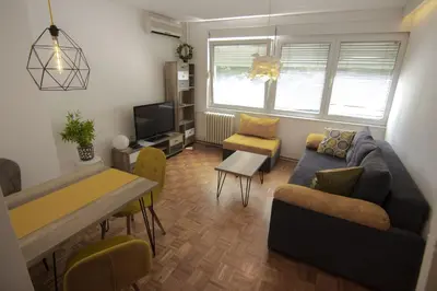 a living room with a couch and a table at Slavija Square Apartments in Belgrade