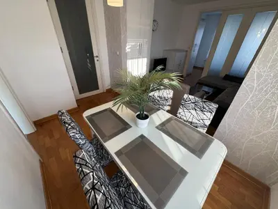 a white table and chairs with a potted plant on it at Apartment Zumbul 85 in Belgrade