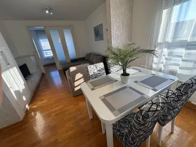 a living room with a white table and chairs at Apartment Zumbul 85 in Belgrade