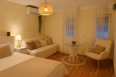 a bedroom with a bed and a couch and a table at Studio Slaviya in Belgrade