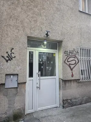 a door to a building with graffiti on it at Studio Slaviya in Belgrade