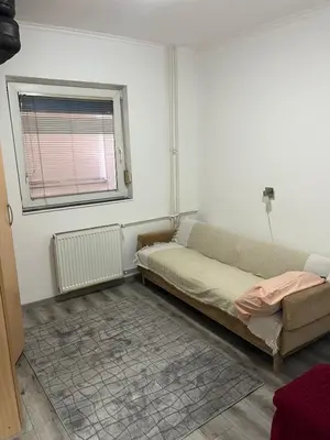 a living room with a couch and a window at Apartman Jovanović in Belgrade