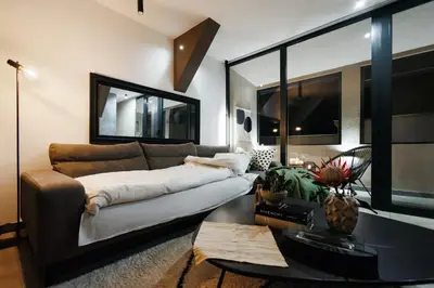 a living room with a couch and a table at Penthouse View with Sauna & Jacuzzi Old Town in Belgrade