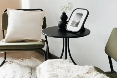 a mirror sitting on a table next to a chair at Penthouse View with Sauna & Jacuzzi Old Town in Belgrade