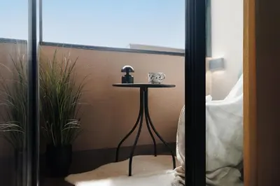 a small table in a room with a window at Penthouse View with Sauna & Jacuzzi Old Town in Belgrade
