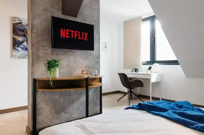 a bedroom with a bed and a desk and a desk at Penthouse View with Sauna & Jacuzzi Old Town in Belgrade