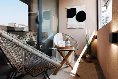 a living room with a chair and a table at Penthouse View with Sauna & Jacuzzi Old Town in Belgrade