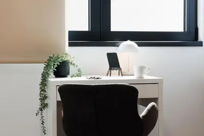 a black chair sitting next to a white desk at Penthouse View with Sauna & Jacuzzi Old Town in Belgrade