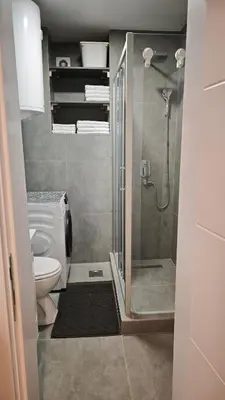 a bathroom with a toilet and a glass shower at House of Mirrors in Belgrade