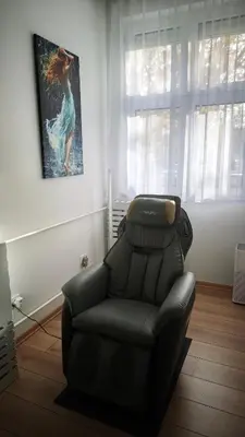 a black leather reclining chair in a living room at House of Mirrors in Belgrade