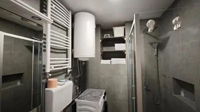 a small bathroom with a toilet and a shower at House of Mirrors in Belgrade