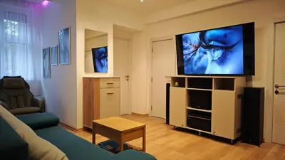 a living room with a couch and a flat screen tv at House of Mirrors in Belgrade