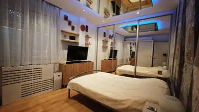 a hospital room with two beds and a television at House of Mirrors in Belgrade