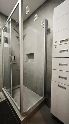 a shower with a glass door in a bathroom at House of Mirrors in Belgrade