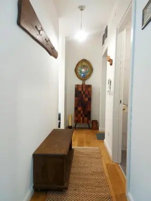 a hallway with a wooden bench in a room at Danube Riverfront 8 in Belgrade