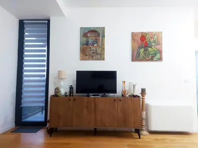 a living room with a tv on a wooden cabinet at Danube Riverfront 8 in Belgrade