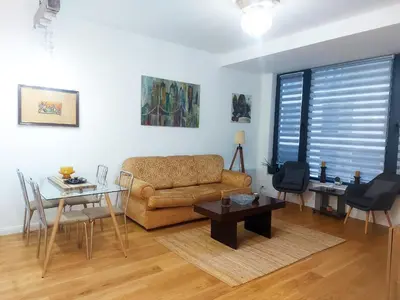 a living room with a couch and a table at Danube Riverfront 8 in Belgrade